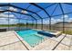 Refreshing pool and spa inside a screened lanai overlooks a picturesque lake view beyond the backyard at 11504 Sage Canyon Dr, Riverview, FL 33578