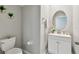 Well-lit powder room with a decorative mirror, white vanity, and modern fixtures creating a clean and stylish space at 11504 Sage Canyon Dr, Riverview, FL 33578
