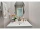 Close-up of powder room vanity featuring modern faucet, decorative accessories, and soft lighting enhancing the design at 11504 Sage Canyon Dr, Riverview, FL 33578