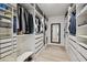 Large walk-in closet with custom shelving, drawers, and a full-length mirror at 11504 Sage Canyon Dr, Riverview, FL 33578