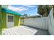 Backyard of home with wood deck and green exterior at 121 86Th Ter, Treasure Island, FL 33706