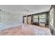 Spacious living room with terracotta tile floor, large window, and ceiling fan at 121 86Th Ter, Treasure Island, FL 33706