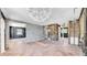 Spacious living room shows the tile floor and unique light fixture at 121 86Th Ter, Treasure Island, FL 33706