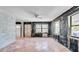 Bright living room featuring large windows and terracotta tile at 121 86Th Ter, Treasure Island, FL 33706