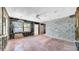 Bright living room with terracotta tile floor, large window, and ceiling fan at 121 86Th Ter, Treasure Island, FL 33706