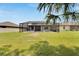 Lovely lawn including the screened-in pool area with lush green grass and a white perimeter fence for privacy at 12134 Creek Preserve Dr, Riverview, FL 33579