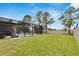 A large grassy backyard offers space for recreation, with a view of the screened-in pool and privacy fence at 12134 Creek Preserve Dr, Riverview, FL 33579