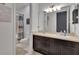 Bathroom featuring a double vanity, dark cabinets and a shower with a shower curtain at 12134 Creek Preserve Dr, Riverview, FL 33579
