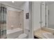 Bright bathroom features a shower-tub combo with tile surround and a modern vanity at 12134 Creek Preserve Dr, Riverview, FL 33579