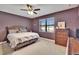 Cozy bedroom with soft carpet, natural light, and ceiling fan at 12134 Creek Preserve Dr, Riverview, FL 33579