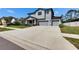 Charming two-story house featuring a wide driveway leading to a two-car garage, surrounded by lush green lawns at 12134 Creek Preserve Dr, Riverview, FL 33579