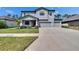 Inviting two-story home with a well-manicured lawn, complemented by a spacious driveway and a two-car garage at 12134 Creek Preserve Dr, Riverview, FL 33579