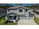 Two story home with a three car garage, lovely front porch and mature landscaping at 12134 Creek Preserve Dr, Riverview, FL 33579