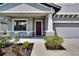 Cozy front porch with seating area, complemented by lush landscaping and a charming exterior at 12134 Creek Preserve Dr, Riverview, FL 33579