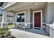 Inviting front porch with seating offers a charming entrance to this lovely home at 12134 Creek Preserve Dr, Riverview, FL 33579