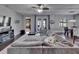 Spacious living room with modern gray sofa, and lots of natural light at 12134 Creek Preserve Dr, Riverview, FL 33579