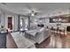 Open-concept living area features a large gray sofa, dining, and kitchen area at 12134 Creek Preserve Dr, Riverview, FL 33579