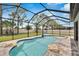 A stunning screened pool with rock accents, blue tile, and a spacious patio is great for Gathering gatherings at 12134 Creek Preserve Dr, Riverview, FL 33579