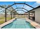 A gorgeous backyard featuring a screened in pool with clear blue water, stone accents, and a patio area at 12134 Creek Preserve Dr, Riverview, FL 33579