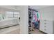 Main bedroom with a walk-in closet with organized shelves and an ensuite bathroom at 1328 Pasadena S Ave # 608, South Pasadena, FL 33707