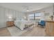 Serene bedroom with wood-look floors, neutral decor, and a large window offering natural light at 1328 Pasadena S Ave # 608, South Pasadena, FL 33707