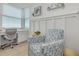 Bright bedroom with a cozy armchair, decorative shelves, and a convenient desk area with a great view at 1328 Pasadena S Ave # 608, South Pasadena, FL 33707