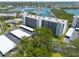 Exterior shot of the building featuring assigned covered parking and mature trees at 1328 Pasadena S Ave # 608, South Pasadena, FL 33707