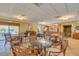 Community room with wicker seating and tables and a partial view of the kitchen at 1328 Pasadena S Ave # 608, South Pasadena, FL 33707
