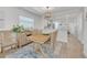 Bright dining room featuring wood look floors and a chandelier with a view of the kitchen at 1328 Pasadena S Ave # 608, South Pasadena, FL 33707