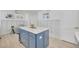 Close up of the kitchen island featuring barstool seating, drawers and open space below at 1328 Pasadena S Ave # 608, South Pasadena, FL 33707