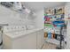 Well-stocked laundry room with plenty of shelving and a washer and dryer at 1328 Pasadena S Ave # 608, South Pasadena, FL 33707