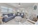 Cozy living room featuring neutral paint, modern ceiling fan and beach themed decor at 1328 Pasadena S Ave # 608, South Pasadena, FL 33707