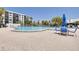 Resort-style community pool with ample seating, lounge chairs, and lush landscaping for relaxation and enjoyment at 1328 Pasadena S Ave # 608, South Pasadena, FL 33707