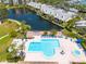 Aerial view of a beautiful pool with ample seating and nearby lake access at 1328 Pasadena S Ave # 608, South Pasadena, FL 33707