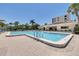 Refreshing outdoor pool area with pristine blue water, bordered by a brick patio and well-maintained landscaping at 1328 Pasadena S Ave # 608, South Pasadena, FL 33707