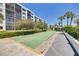 Outdoor shuffleboard courts with lush landscaping, palm trees, and clear blue skies, offering recreational fun at 1328 Pasadena S Ave # 608, South Pasadena, FL 33707
