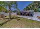Spacious backyard featuring a screened lanai, patio, and privacy fence at 135 Coral Dr, Safety Harbor, FL 34695