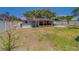 Large, fenced backyard with a screened-in porch and patio at 135 Coral Dr, Safety Harbor, FL 34695