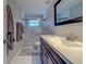 Bright bathroom showcasing a tiled shower and a modern vanity with countertop space at 135 Coral Dr, Safety Harbor, FL 34695