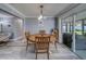 Cozy dining area features wood table, chandelier and sliding glass doors to the sun room at 135 Coral Dr, Safety Harbor, FL 34695