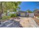 Single-story home showcasing a well-kept lawn, a private driveway, and lush foliage at 135 Coral Dr, Safety Harbor, FL 34695