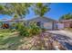 Charming home featuring a well-maintained lawn, and a delightful blue front door at 135 Coral Dr, Safety Harbor, FL 34695