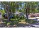 Charming single-story home shaded by mature trees, enhanced by a lush front lawn at 135 Coral Dr, Safety Harbor, FL 34695