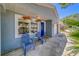 Inviting front porch featuring blue chairs, hanging flower baskets, and a decorative blue front door at 135 Coral Dr, Safety Harbor, FL 34695