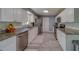 Well-lit kitchen has granite counters, stainless steel appliances and gray wood-look floors at 135 Coral Dr, Safety Harbor, FL 34695