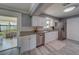 Modern kitchen features granite countertops, stainless steel appliances and gray wood-look floors at 135 Coral Dr, Safety Harbor, FL 34695