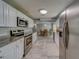 Spacious kitchen view showcases stainless appliances, and gray wood-look floors at 135 Coral Dr, Safety Harbor, FL 34695