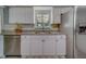 Charming kitchen featuring granite countertops, stainless steel appliances and white cabinetry at 135 Coral Dr, Safety Harbor, FL 34695