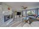 Cozy living room features stone fireplace, modern flooring, and comfortable seating at 135 Coral Dr, Safety Harbor, FL 34695