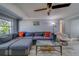 Comfortable living room with a large sectional sofa, fan and a modern coffee table at 135 Coral Dr, Safety Harbor, FL 34695